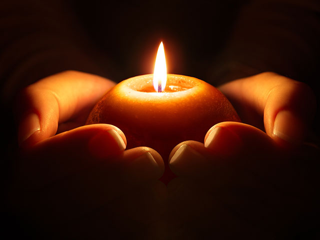 hands holding candle