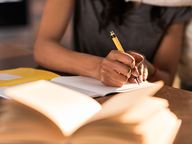 woman writing in journal