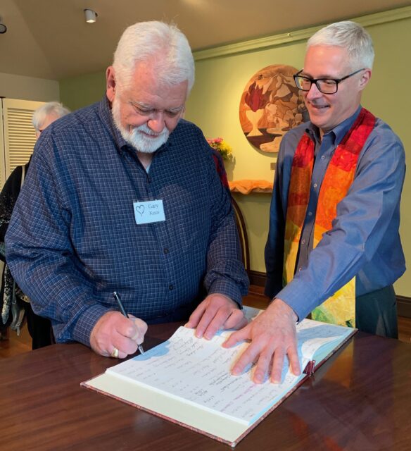 Gary K signing the membership book