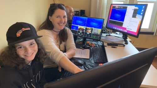 Child and woman at computer screens