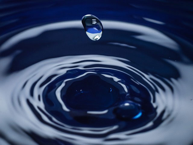 drop of water over ripples outward