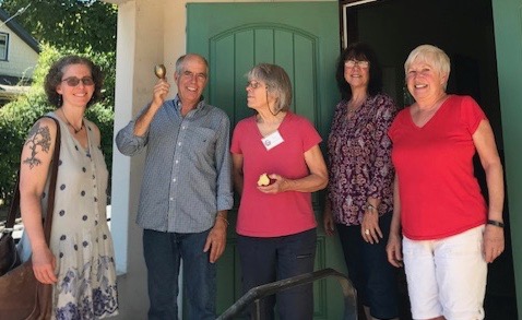 Jo Waters, Paul Elias, Janet Dunstan, Reine Thibault, Theresa Houtman ring bell by front entrance