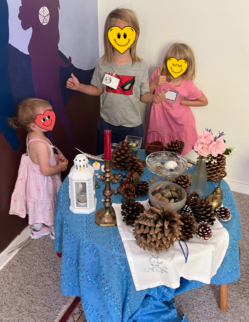 three children in Kids Connection building the altar