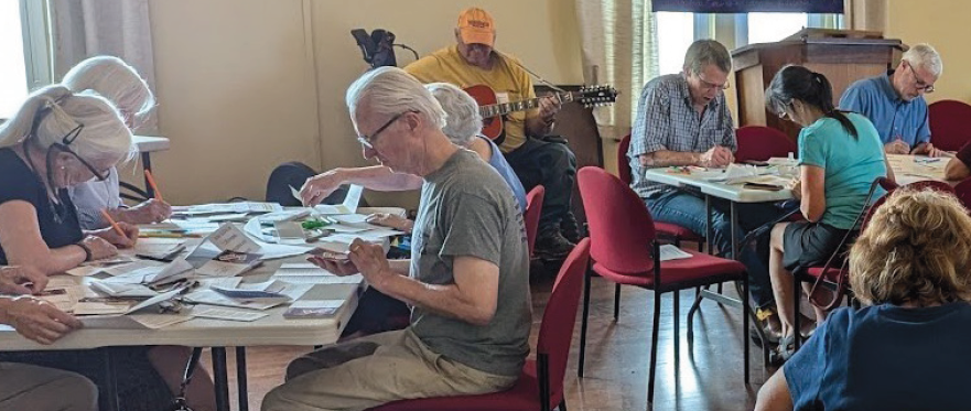 during a worship service, members write Get-Out-the-Vote postcards, phone-bank & send text messages to potential voters, and play music