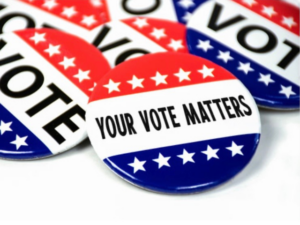 buttons/badges with red-white-blue stripes and white stars that say, "VOTE" and one button in front that says, "YOUR VOTE MATTERS."